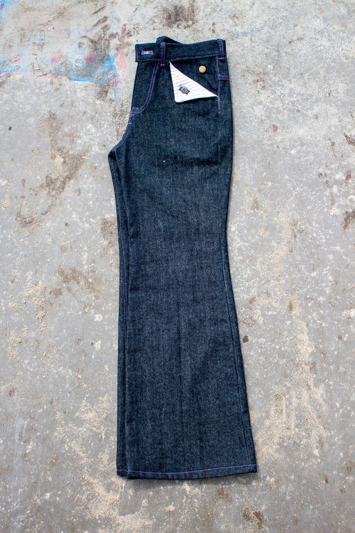 Pair of blue jeans on a textured concrete surface